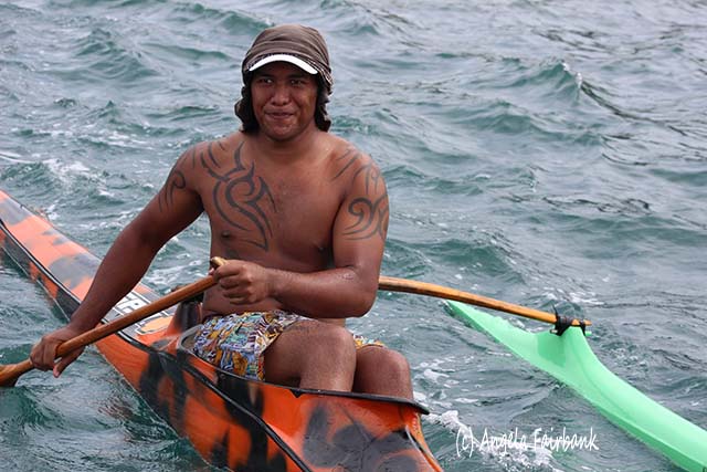 Polynesian man in outrigger canoe, Huahine, French Polynesia, copyright Angela Fairbank
