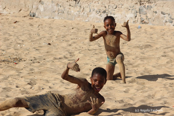 boys fooling around in sand at sal rei