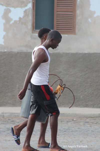 young men carrying a bucket sal rei