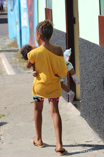 girl carrying baby