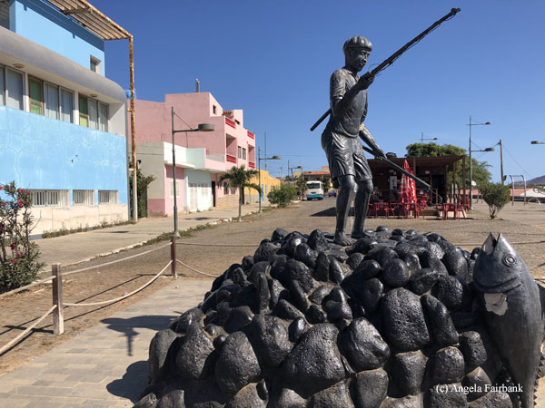 statue of man fishing in palmeira